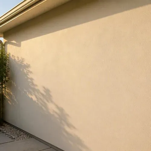 Repaired stucco wall textured to match the original and freshly painted