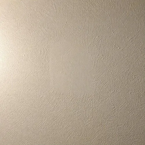 Orange peel texture blended out over a wall patch so the edge of the repair disappears